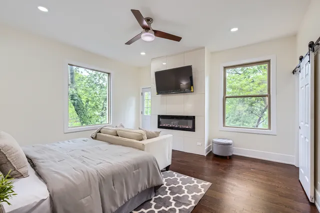 a spacious bedroom with a large bed and a flat screen tv