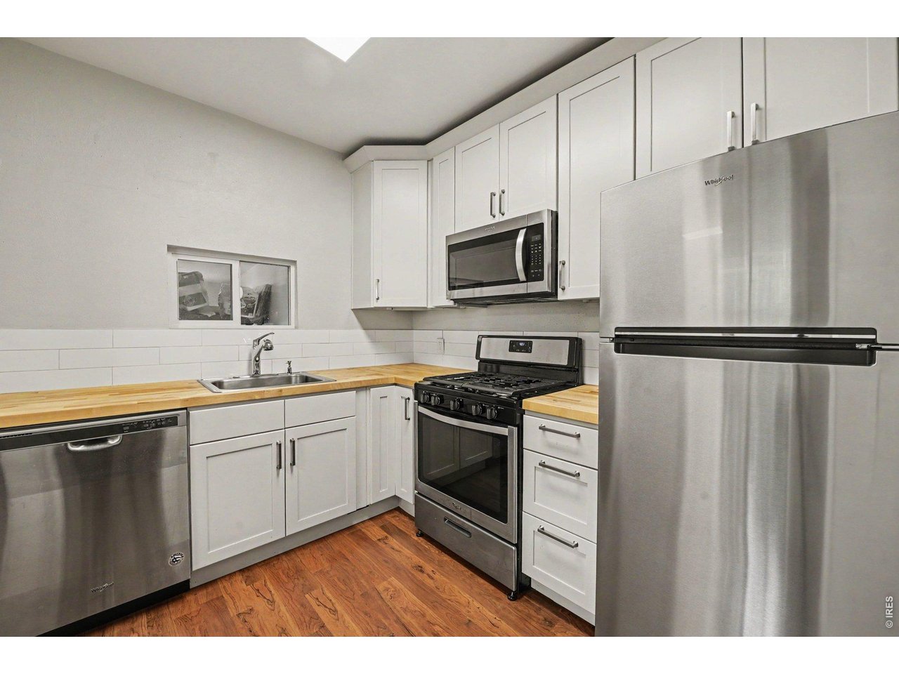 427 9th Street Greeley, CO 80631 - Photo 12 of 22 a kitchen with stainless steel appliances a refrigerator sink and microwave