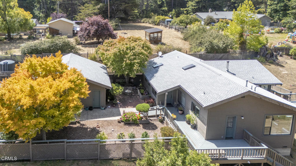 an aerial view of a house with a yard and trees