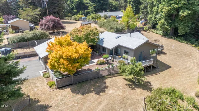 an aerial view of a house with a yard and garden