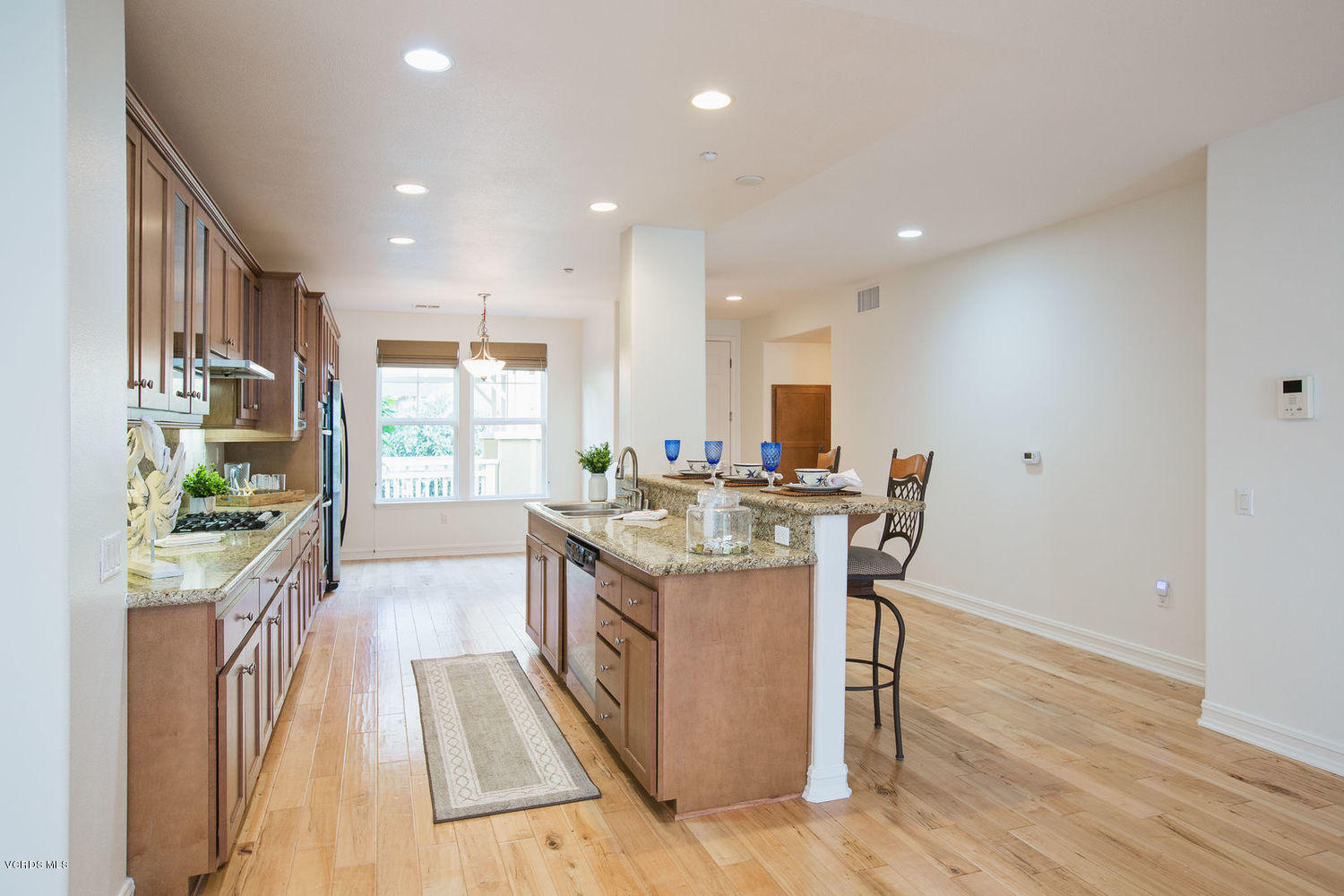 1533 Windshore Way Oxnard, CA 93035 - Photo 12 of 28 a kitchen with stainless steel appliances granite countertop a stove and a wooden floors