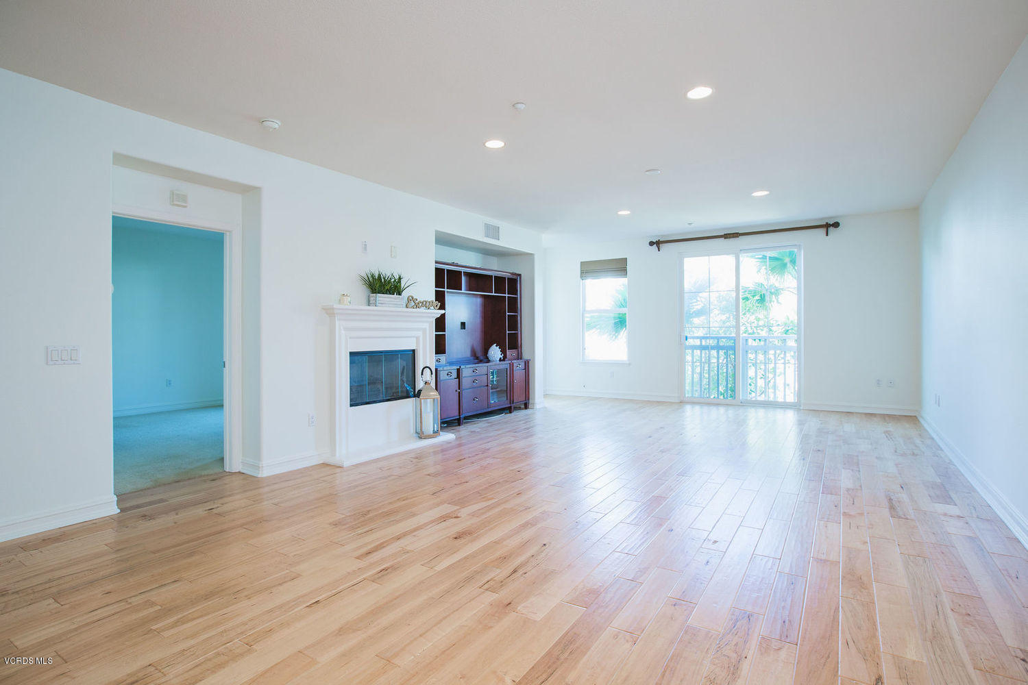 1533 Windshore Way Oxnard, CA 93035 - Photo 14 of 28 a view of a livingroom with wooden floor and a fireplace