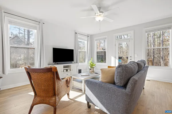 a living room with furniture and wooden floor