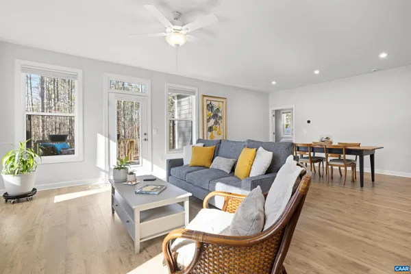 a living room with furniture kitchen and a table