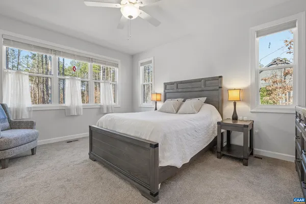 a spacious bedroom with a bed and a couch