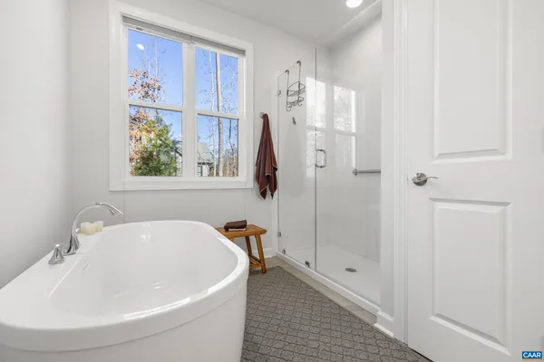 a white bath tub sitting next to a white sink