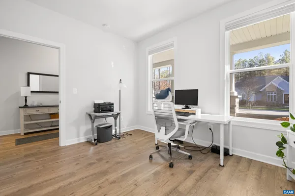 a view of a workspace with furniture and a window