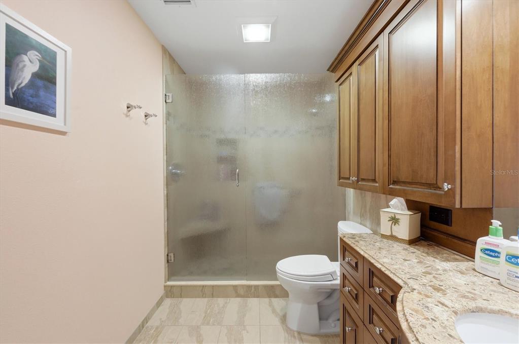 2729 North Beach Road, Unit 211 Englewood, FL 34223 - Photo 29 of 51 a bathroom with a granite countertop toilet and sink