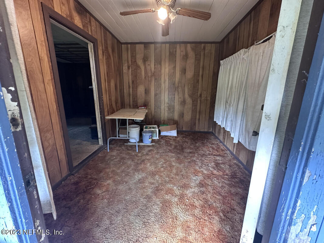 1760 Lilly Road East Jacksonville, FL 32207 - Photo 5 of 18 a view of a room with a fireplace and a porch