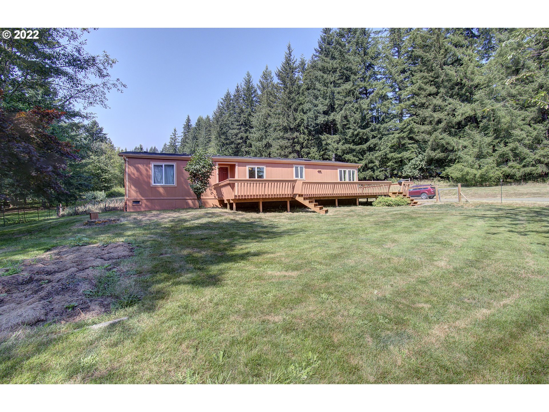 24416 Northeast Berry Road Battle Ground, WA 98604 - Photo 1 of 31 a backyard of a house with table and chairs