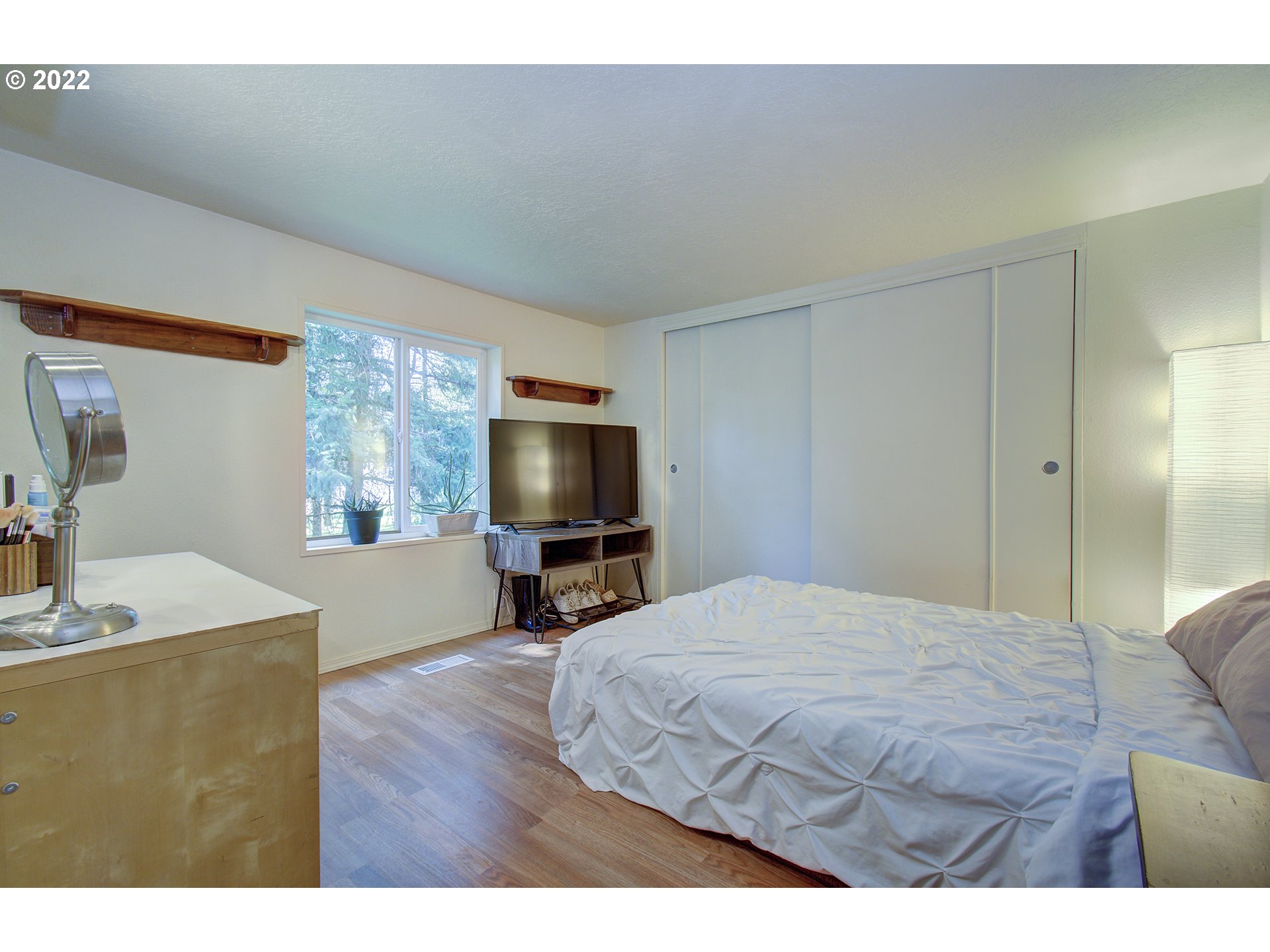 24416 Northeast Berry Road Battle Ground, WA 98604 - Photo 15 of 31 a bedroom with a bed and a flat screen tv