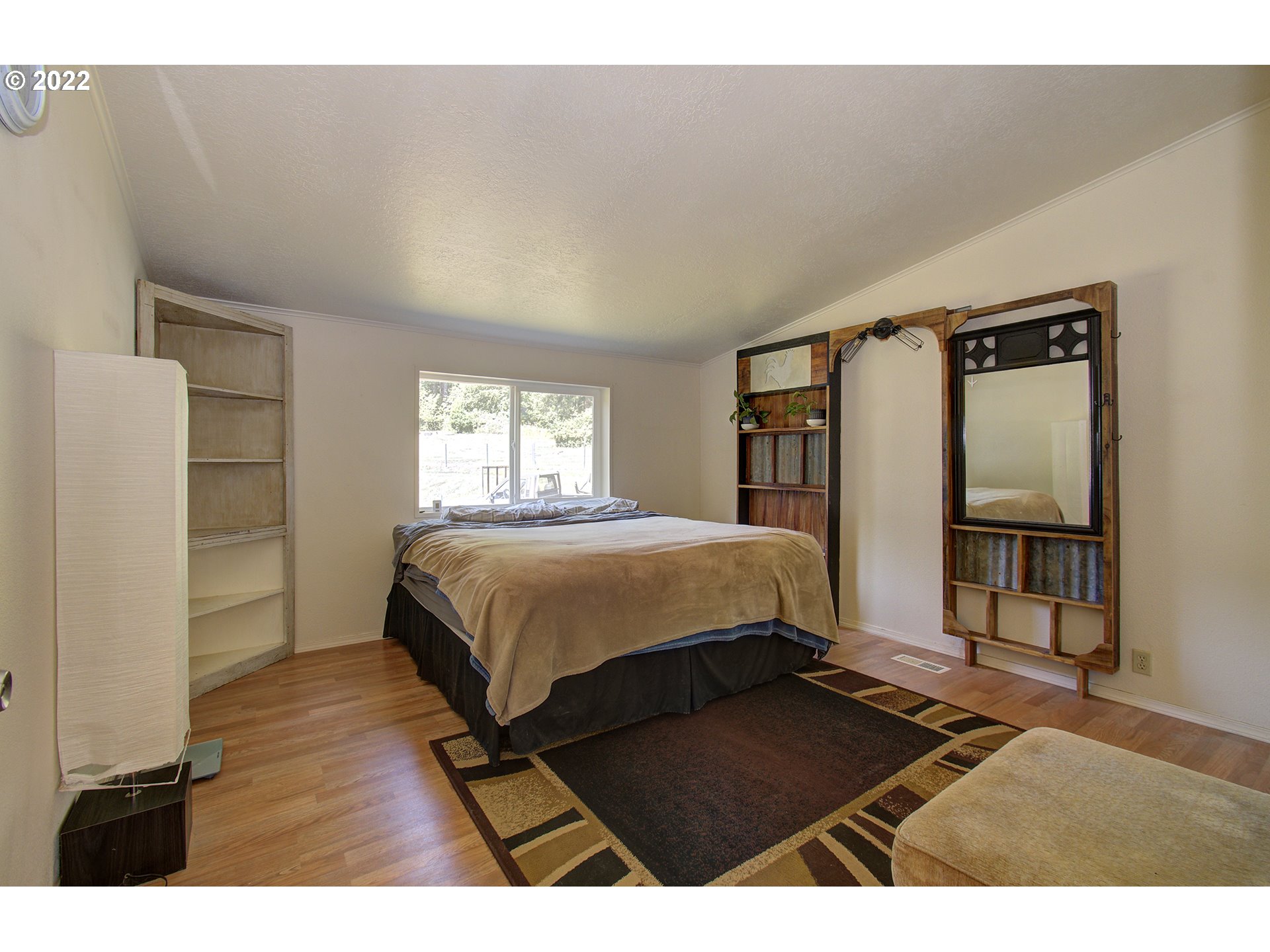 24416 Northeast Berry Road Battle Ground, WA 98604 - Photo 19 of 31 a bedroom with a bed mirror and a window