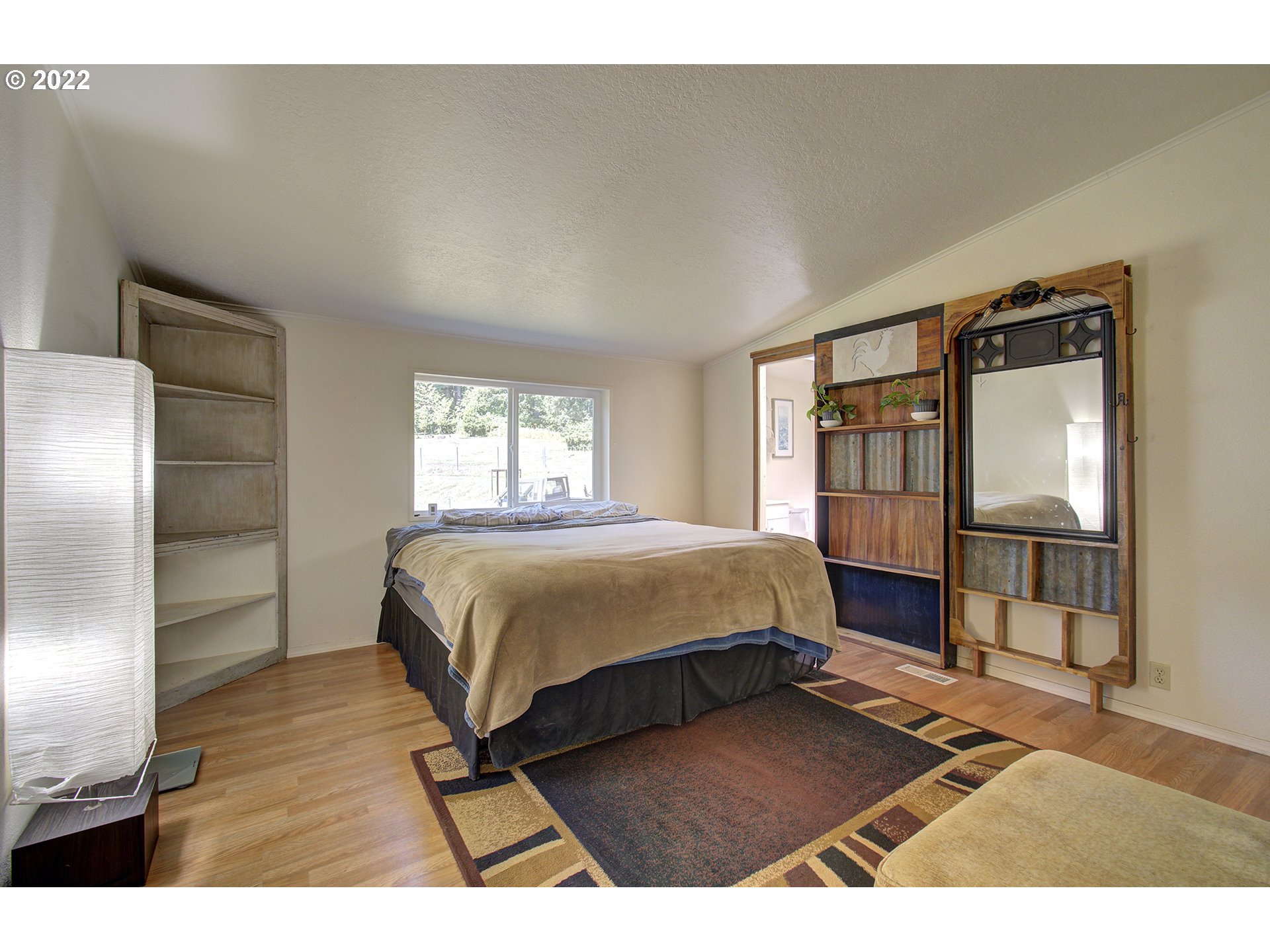 24416 Northeast Berry Road Battle Ground, WA 98604 - Photo 20 of 31 a spacious bedroom with a bed and a window