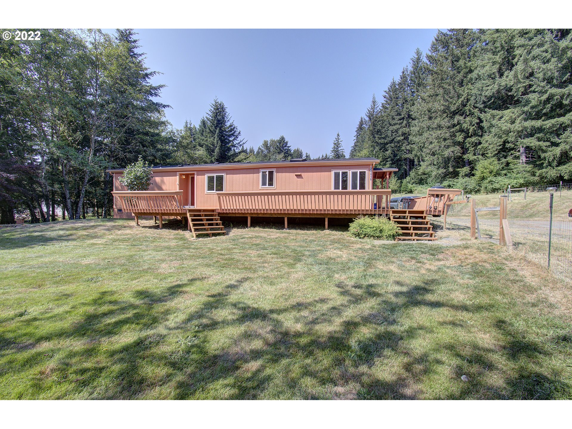 24416 Northeast Berry Road Battle Ground, WA 98604 - Photo 2 of 31 a backyard of a house with table and chairs