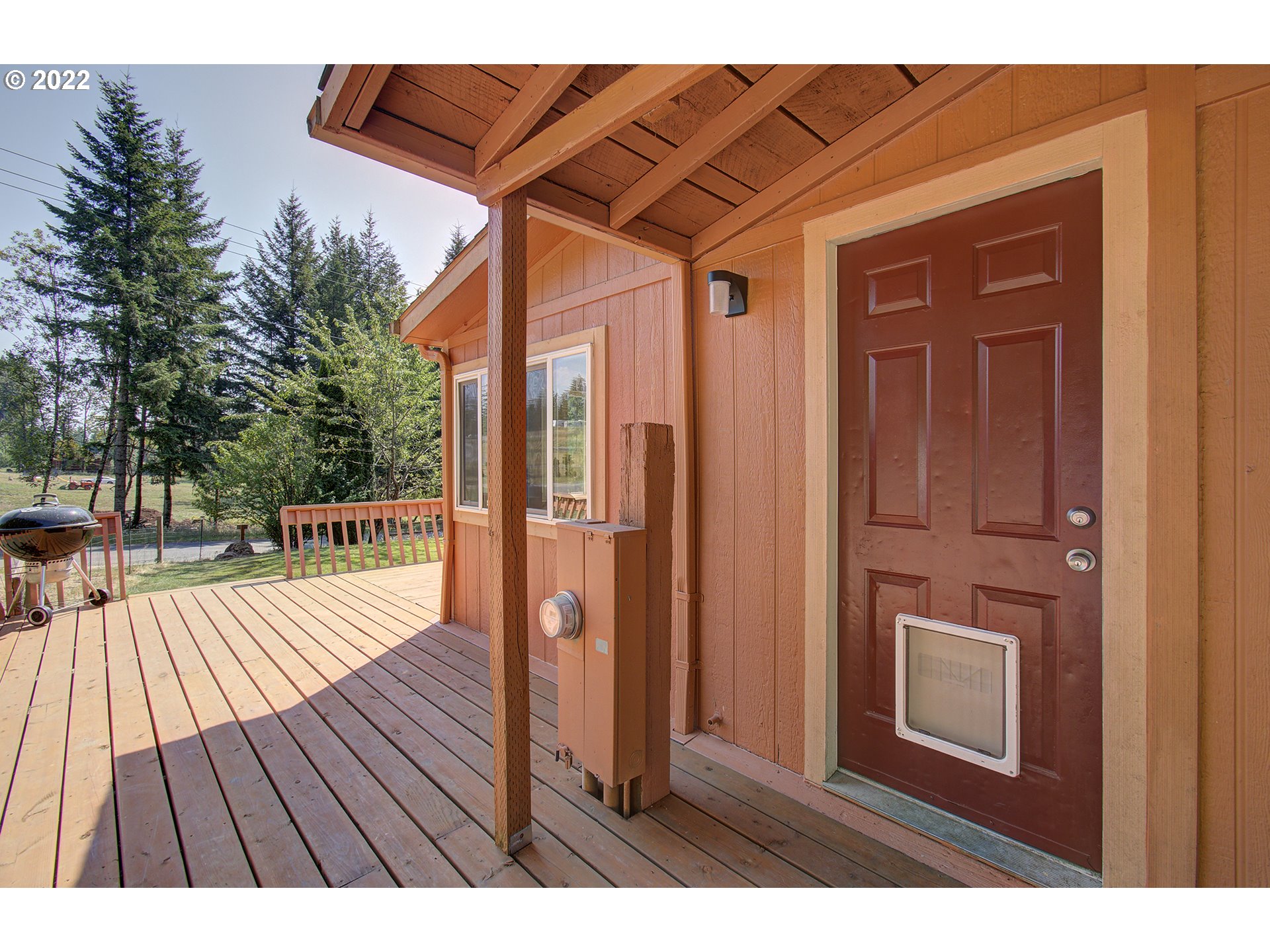 24416 Northeast Berry Road Battle Ground, WA 98604 - Photo 4 of 31 a view of backyard with a deck and wooden floor