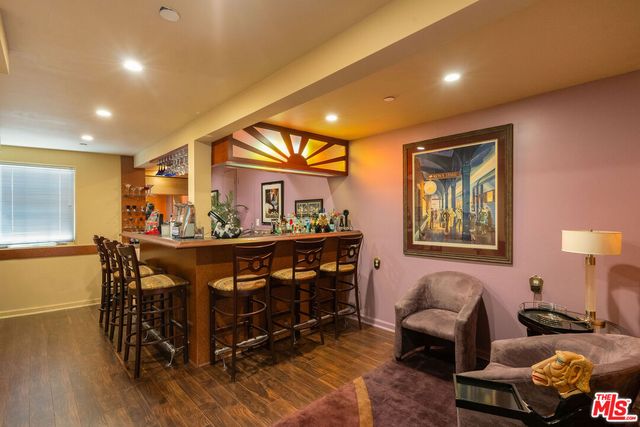 a living room with furniture a window and a wooden floor