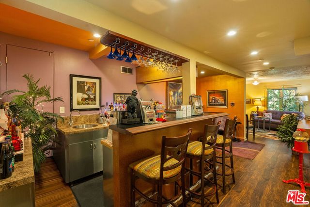 a view of a dining room with furniture and a potted plant