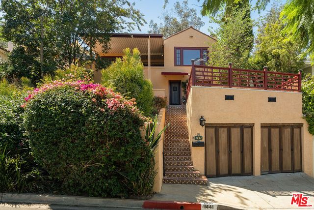 a view of a house with wooden fence