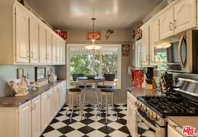 a kitchen with stainless steel appliances a stove a sink and a refrigerator