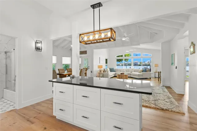 a living room with furniture and kitchen view
