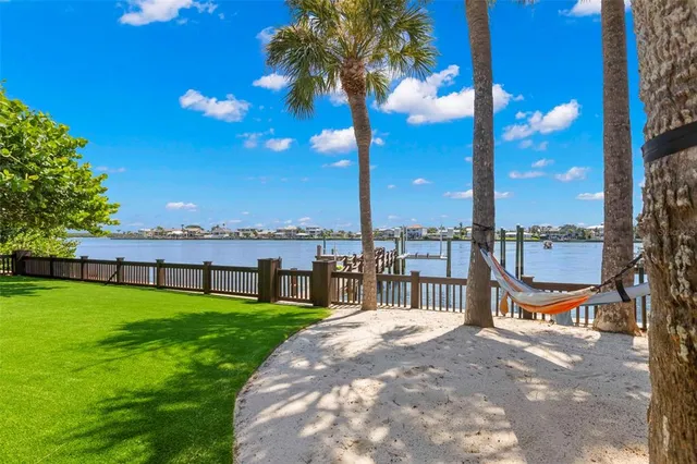 a view of a house with a swimming pool and sitting area