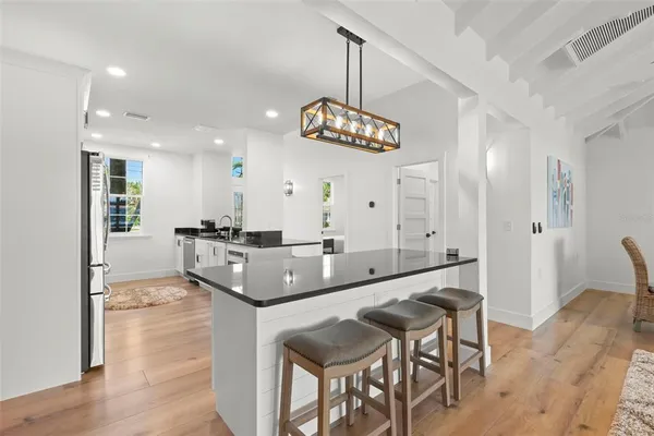 a kitchen with granite countertop stainless steel appliances a stove a sink and a refrigerator