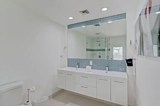 a bathroom with a sink double vanity and a shower