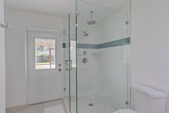 a bathroom with a shower and a toilet