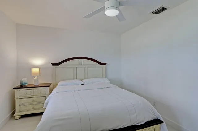 a bedroom with a bed and a mirror