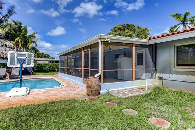 a view of house with swimming pool outdoor seating