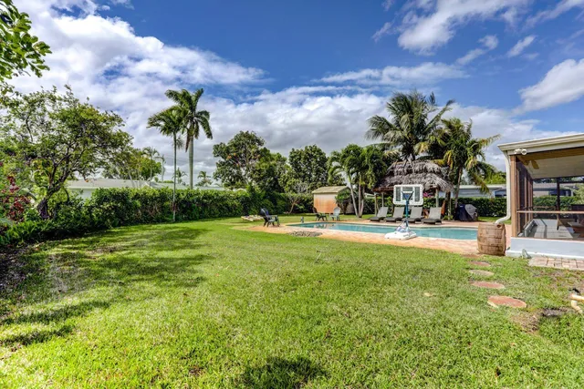 a swimming pool with outdoor seating and garden