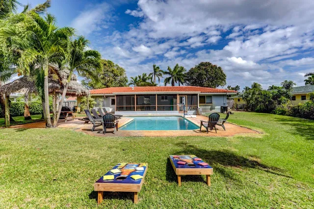 a swimming pool view with a seating space