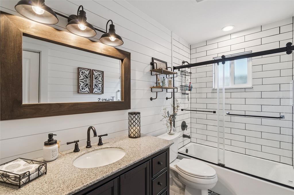 75 Calumet Avenue Ponce Inlet, FL 32127 - Photo 14 of 35 a bathroom with a granite countertop sink toilet and shower
