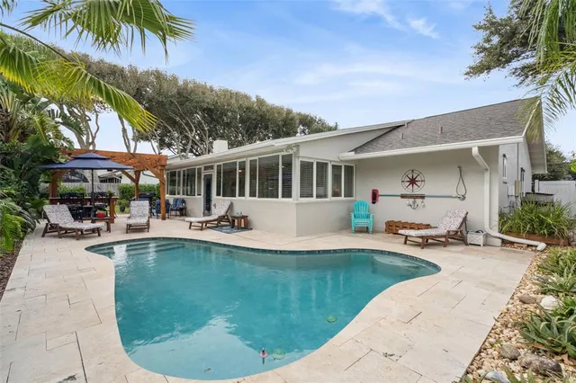 a view of a house with swimming pool and sitting area