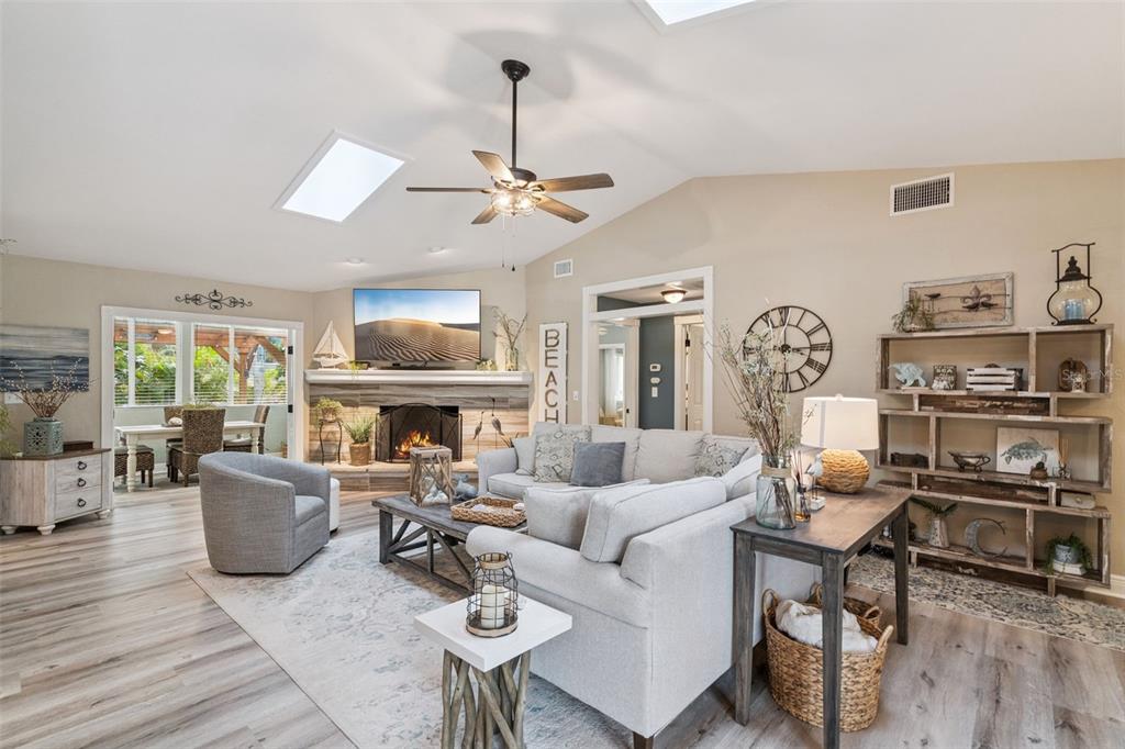 75 Calumet Avenue Ponce Inlet, FL 32127 - Photo 3 of 35 a living room with furniture a rug and a chandelier