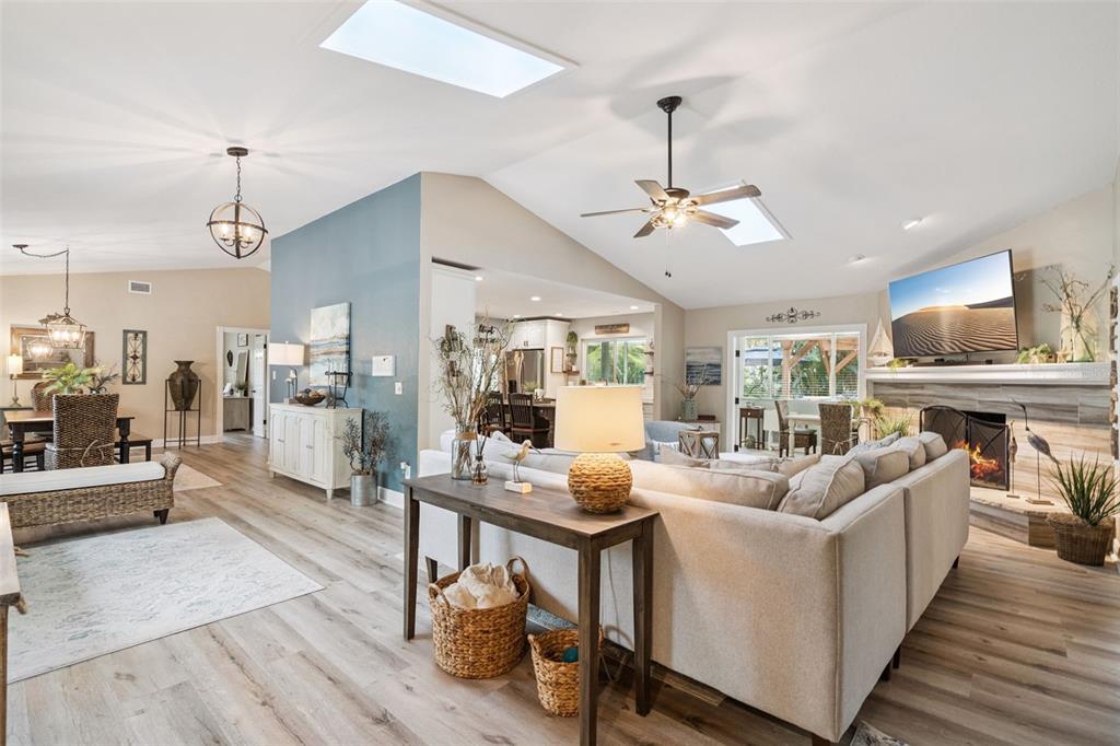 75 Calumet Avenue Ponce Inlet, FL 32127 - Photo 4 of 35 a living room with furniture a fireplace and a chandelier