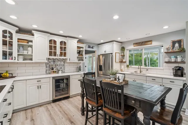 a kitchen with a table chairs stove and cabinets
