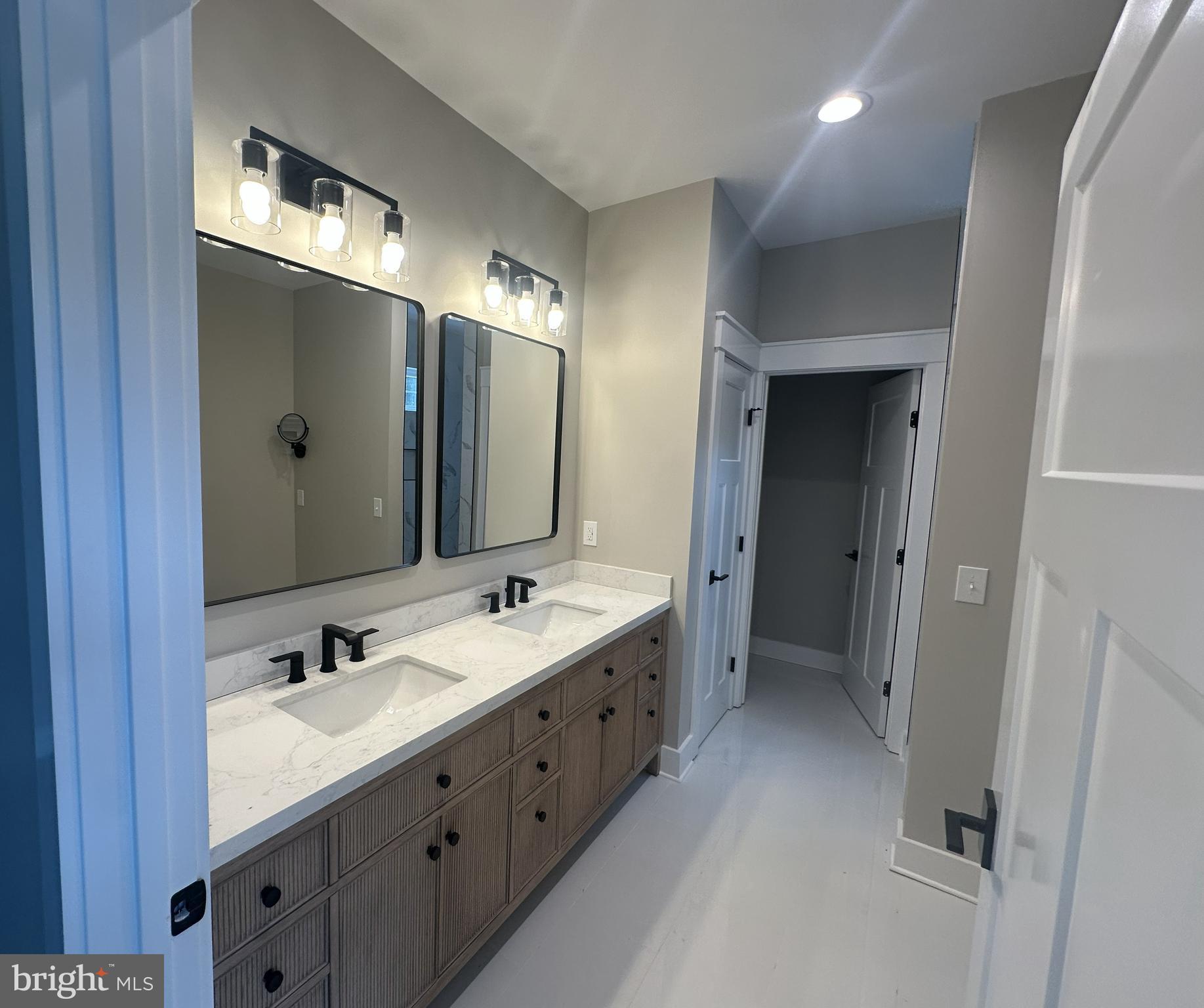 19426 Parsons Road Georgetown, DE 19947 - Photo 12 of 18 a bathroom with a double vanity sink and mirror