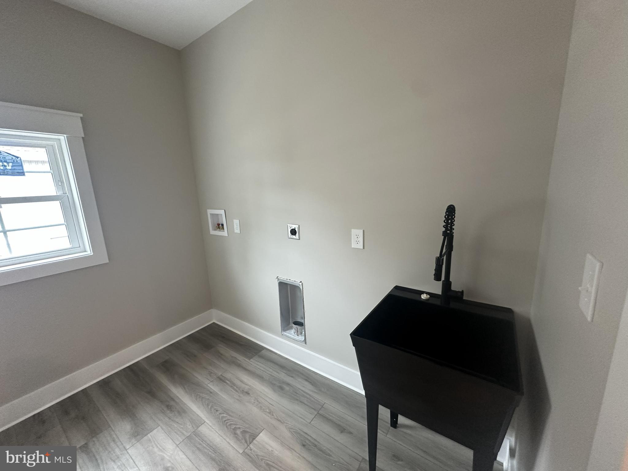 19426 Parsons Road Georgetown, DE 19947 - Photo 18 of 18 a view of a workspace with wooden floor and a window