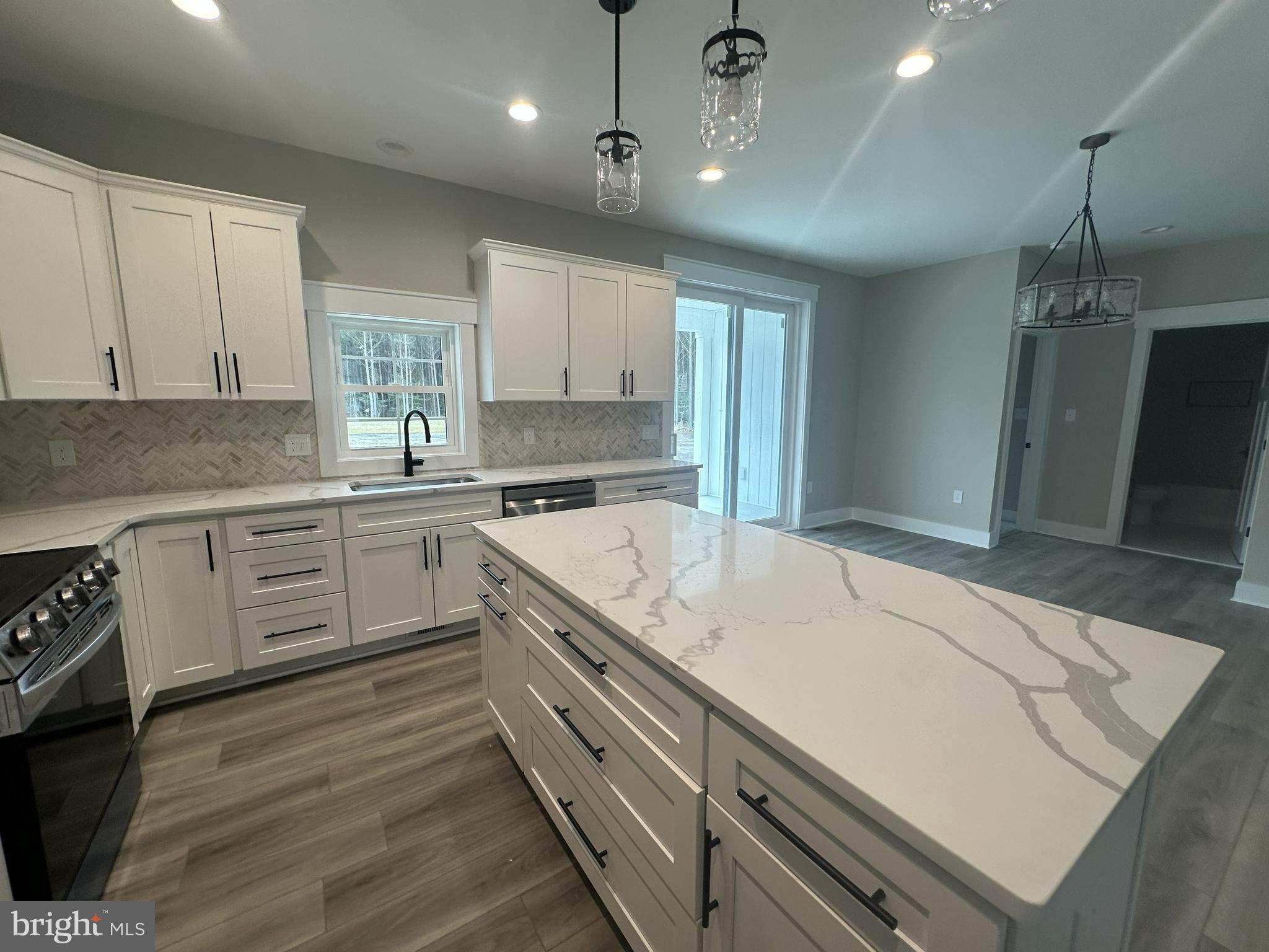19426 Parsons Road Georgetown, DE 19947 - Photo 4 of 18 a kitchen with a sink stove and cabinets