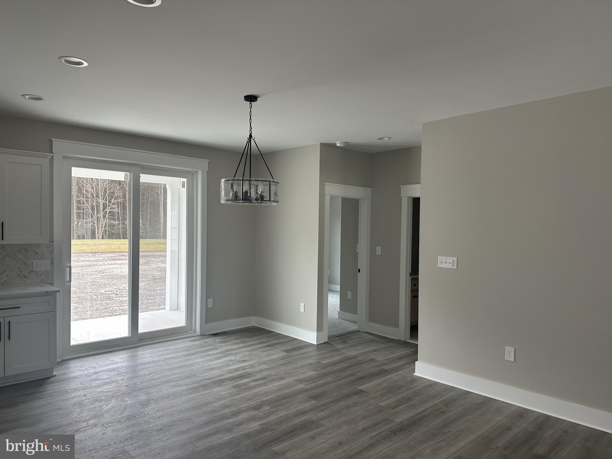 19426 Parsons Road Georgetown, DE 19947 - Photo 6 of 18 an empty room with wooden floor and windows