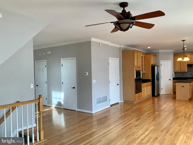 a view of empty room with wooden floor and fireplace
