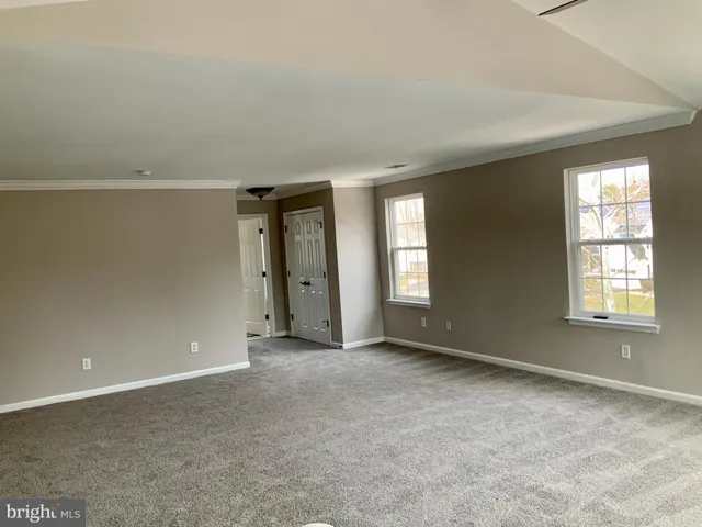 a kitchen with kitchen island a counter space a sink stove and cabinets