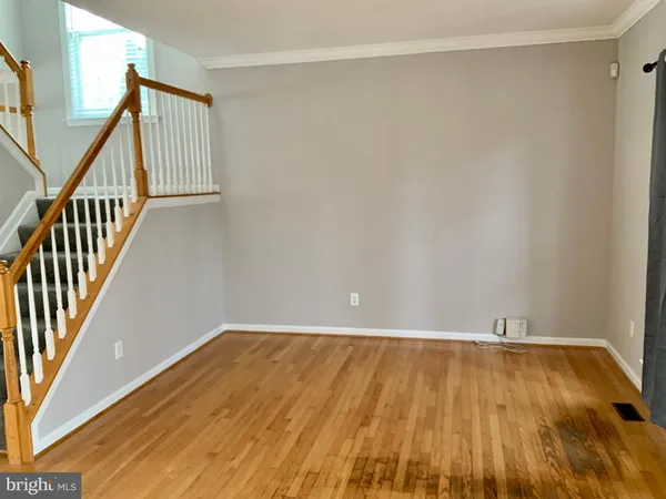 a view of a room with wooden floor and staircase
