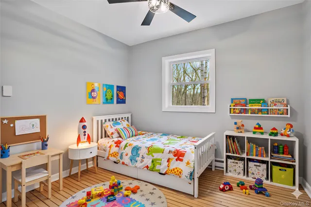 a bedroom with baby toys and a book shelf