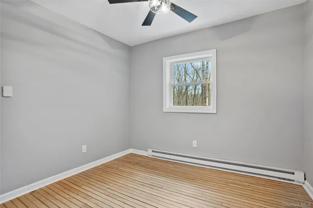 a view of room with window and wooden floor
