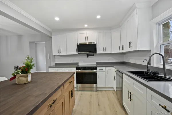 a kitchen with a sink stove and cabinets