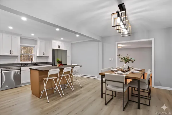 a view of a dining room with furniture and wooden floor