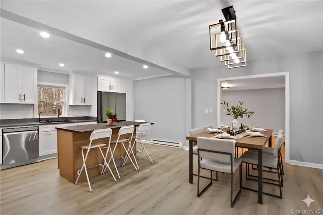 a view of a dining room with furniture and wooden floor