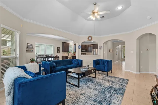 a living room with furniture a rug and a chandelier